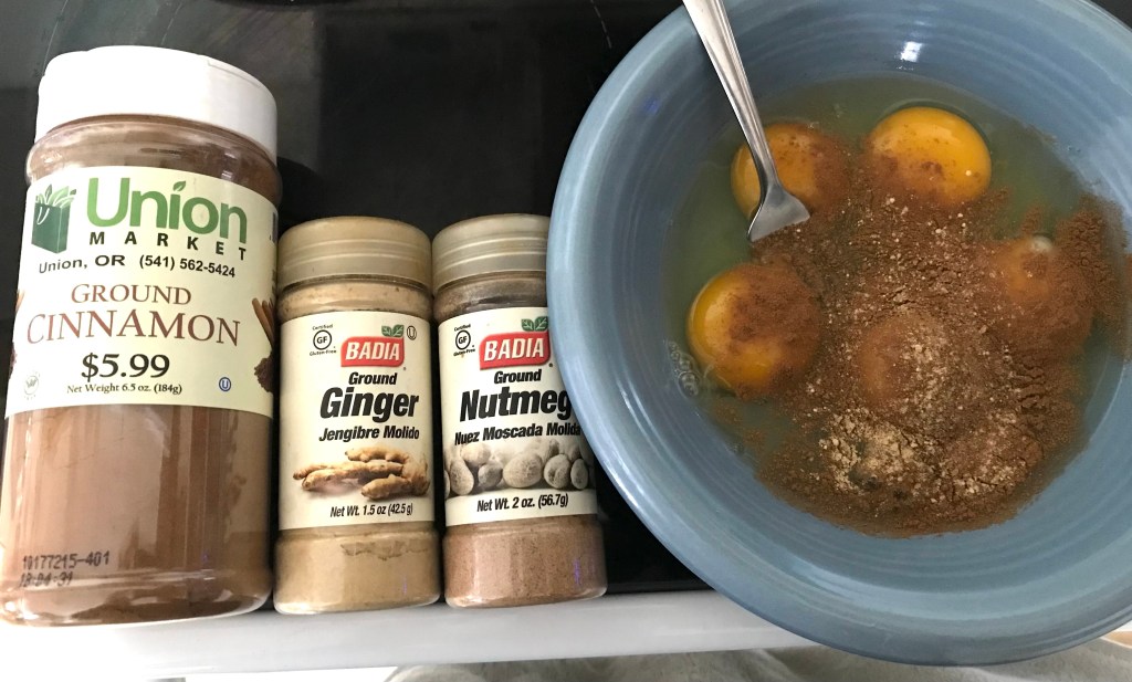 5 eggs in bowl with cinnamon, ginger, and nutmeg
