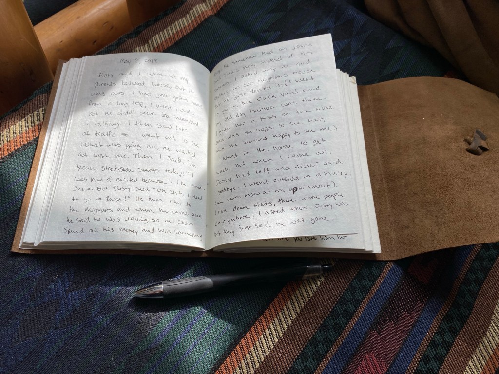Opened pages of a leather journal that has many pages written in it recalling past dreams