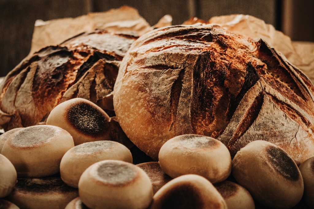 Baked round loaves of sourdough bread, and rolls