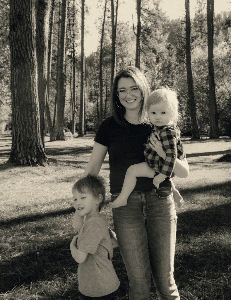 A professional photo of my two kids (4yo & 1yo) and myself (mama) in black and white amongst tall pines trees. Photo credit: Beatrice Smith Photography 