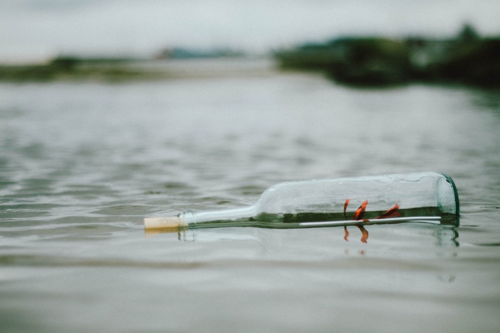 Message in a bottle floating in the water